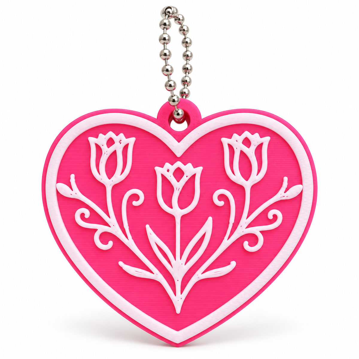 Hot pink heart keychain with raised white tulip flower design and silver ball chain