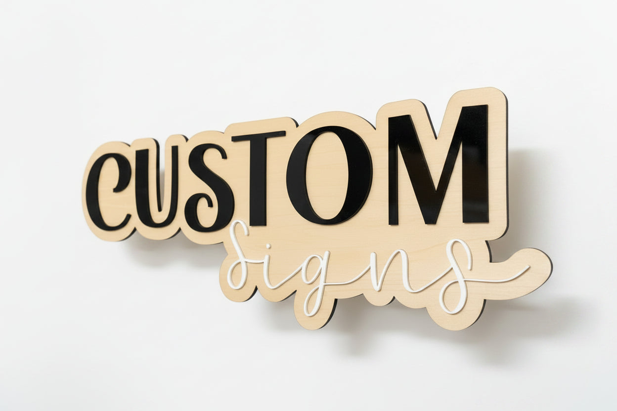 Wooden sign with 'CUSTOM Signs' text in a workshop setting