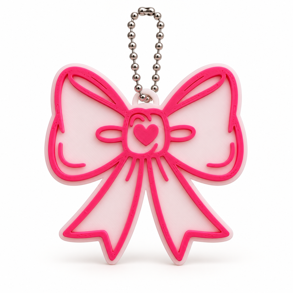 Pink and white 3D printed bow keychain with heart detail and silver ball chain